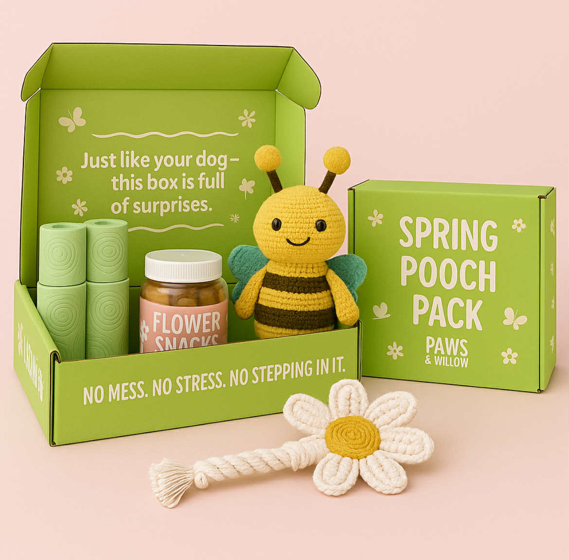 Green box labeled 'Spring Pooch Pack' with a bee-themed toy, flower snacks, and a daisy rope toy on a pink background.